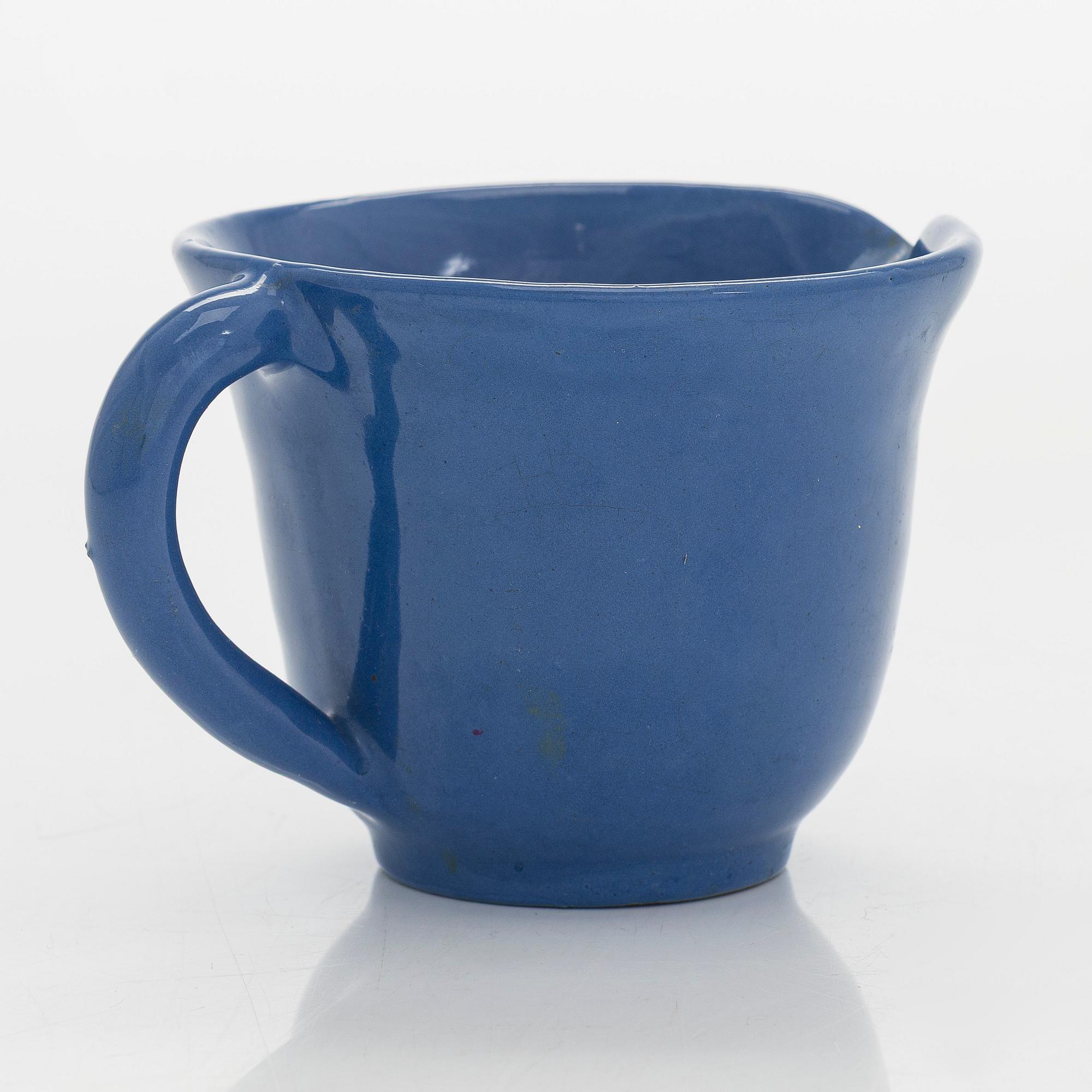 Marita Lybeck, a set of three ceramic plates and cream jug, red clay, signed ML.