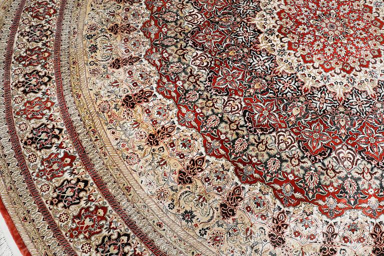 An Oriental silk rug, diameter 256 cm.