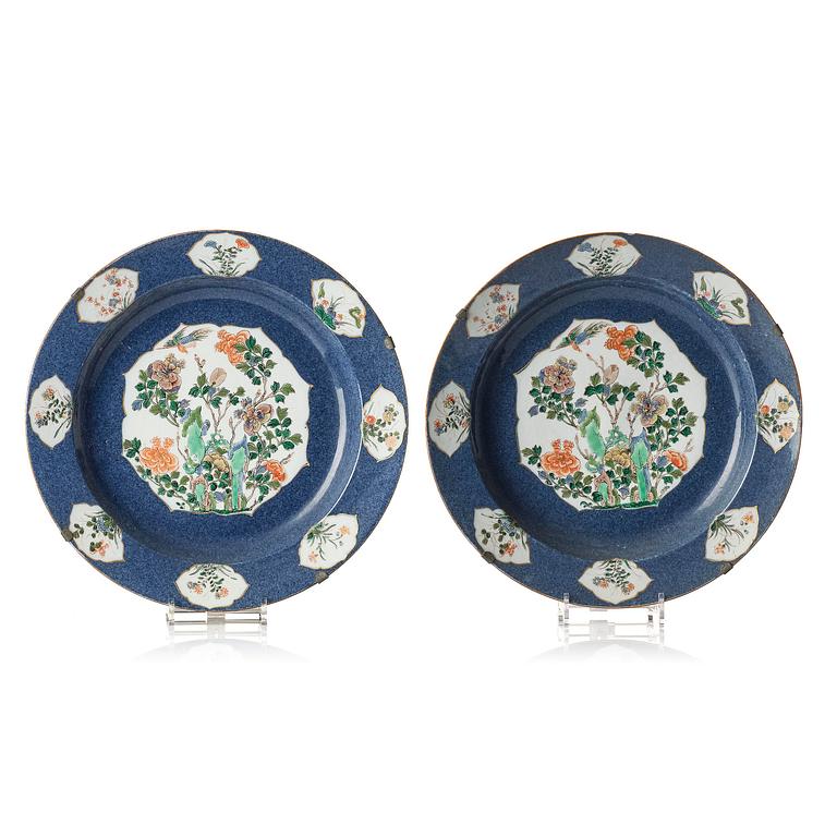 A fine pair of large powder-blue-ground famille-verte 'flowering garden' dishes, Qing dynasty.