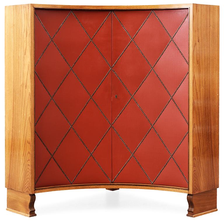 An Otto Schulz elm corner cabinet, the doors with red, artificial leather by Boet Gothenburg.