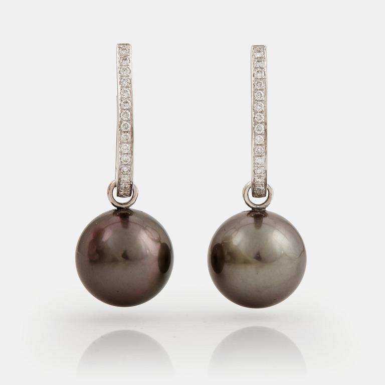A pair of cultured Tahiti pearl and brilliant cut diamond earrings.