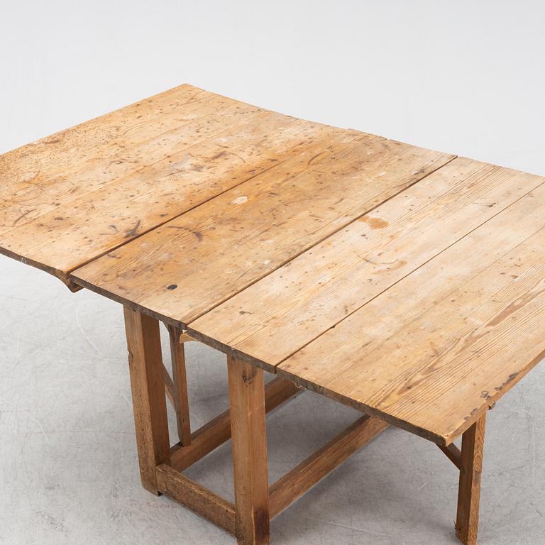 A pine gateleg table, 19th Century.