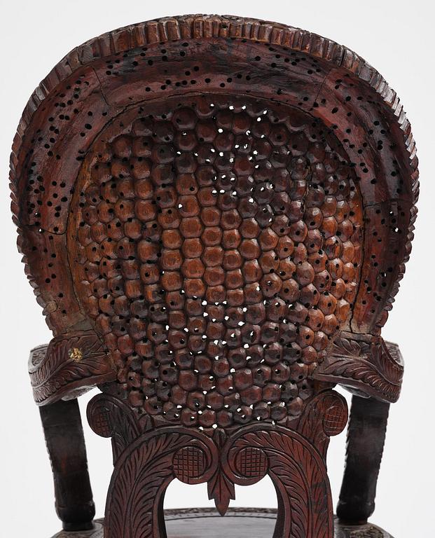 A pair of carved 'blackwood' armchairs, Bombay presidency, British Raj, circa 1880.