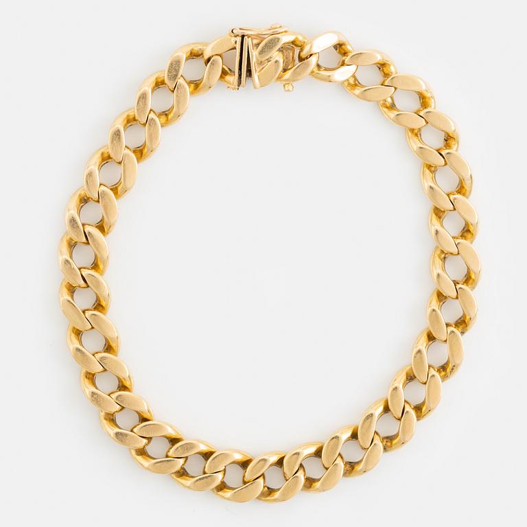 18K gold curb link bracelet.