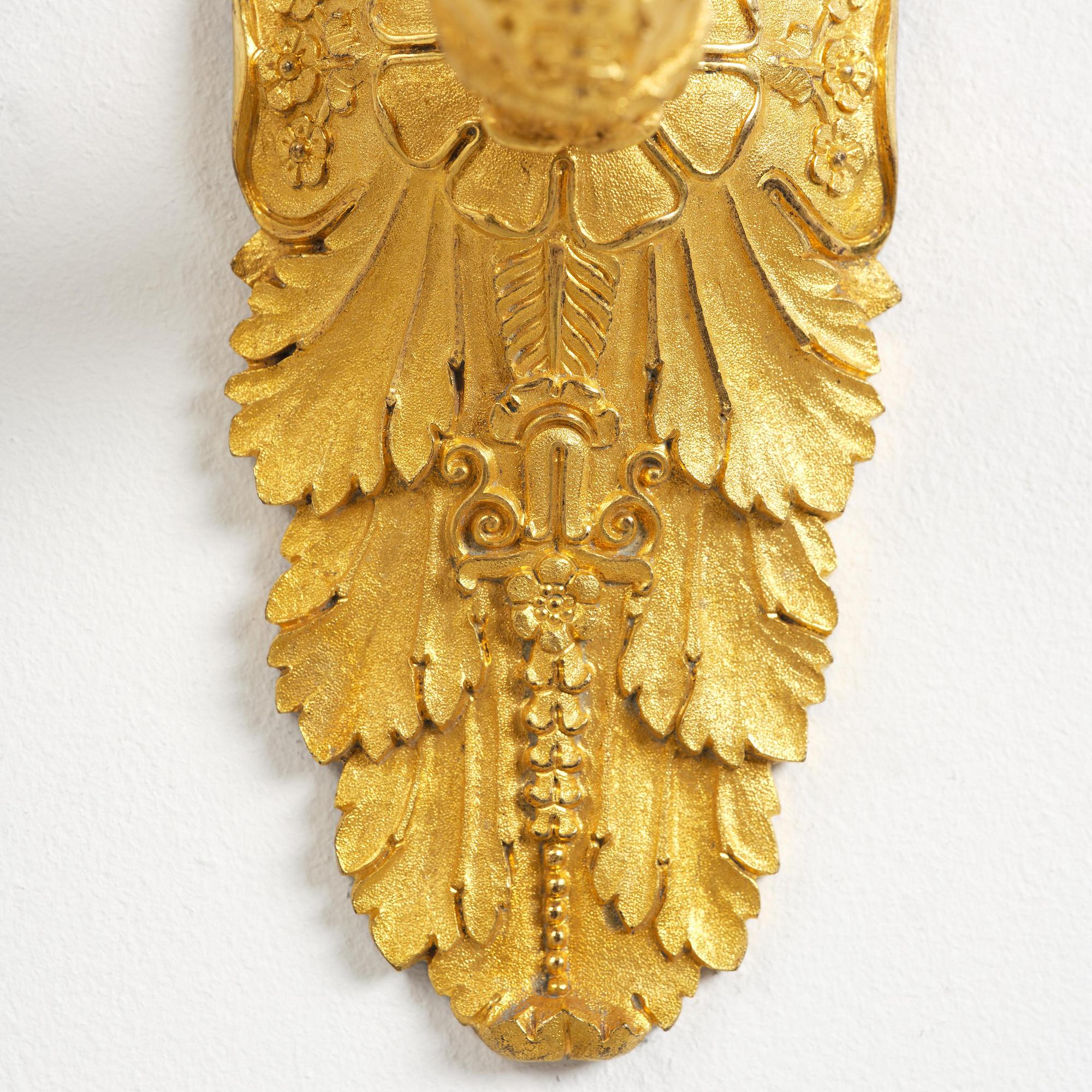 A pair of French Empire five-branch gilt and patinated bronze appliques, first part 19th century.