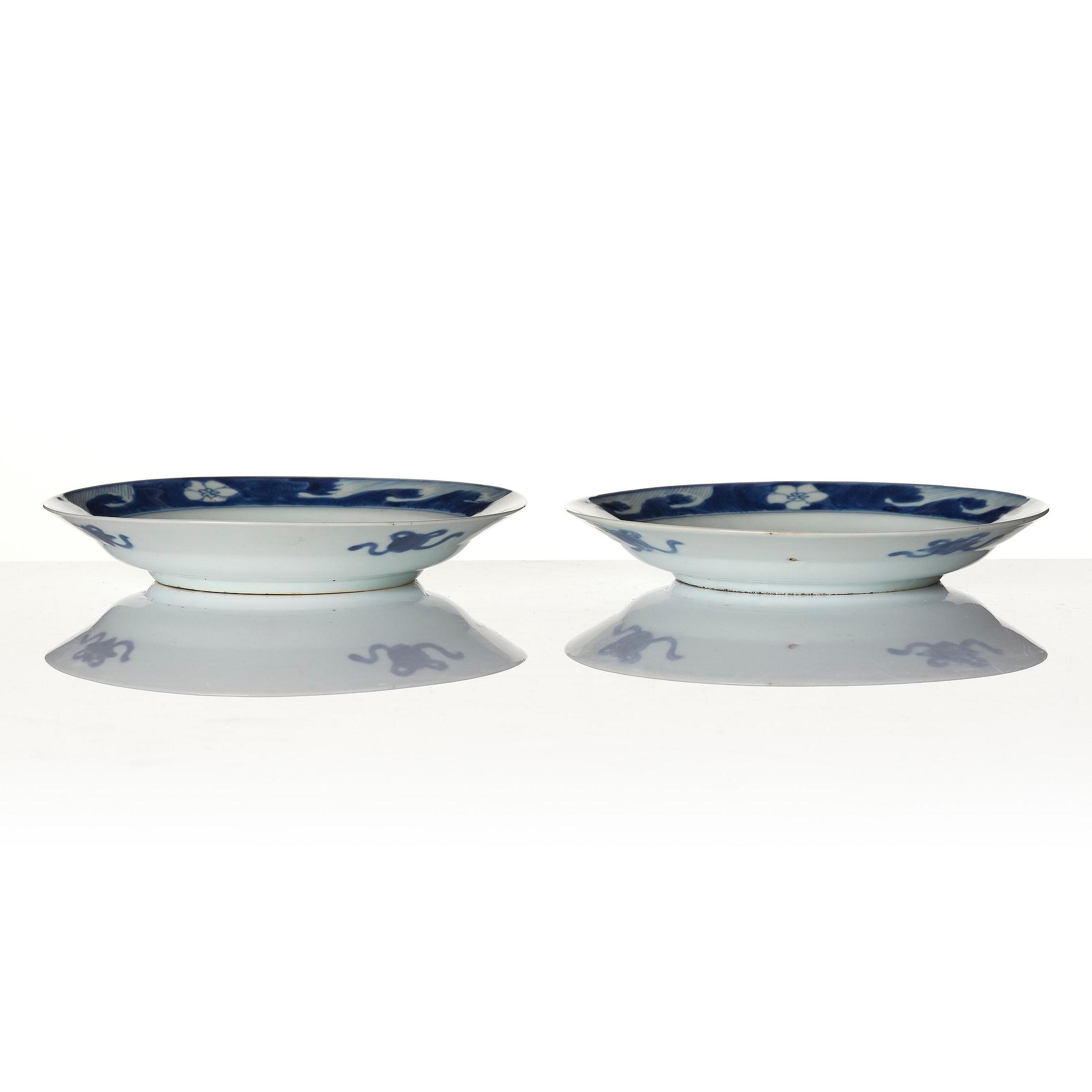 A pair of blue and white 'dragon and fish dishes', Qing dynasty, Kangxi (1662-1722).