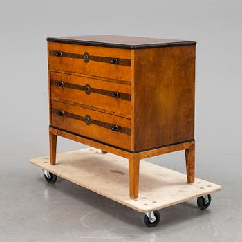 An art déco chest of drawers.