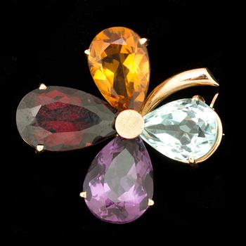 An aquamarine, amethyst, citrine and garnet brooch.