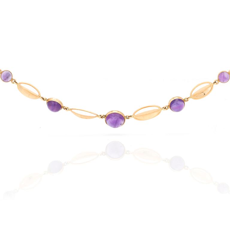 A necklace with round, cabochon-cut amethysts.