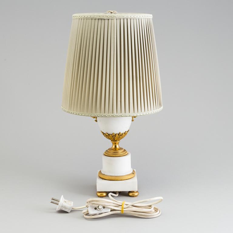 A late 19th century French Louis XVI-style marble and brass table lamp.