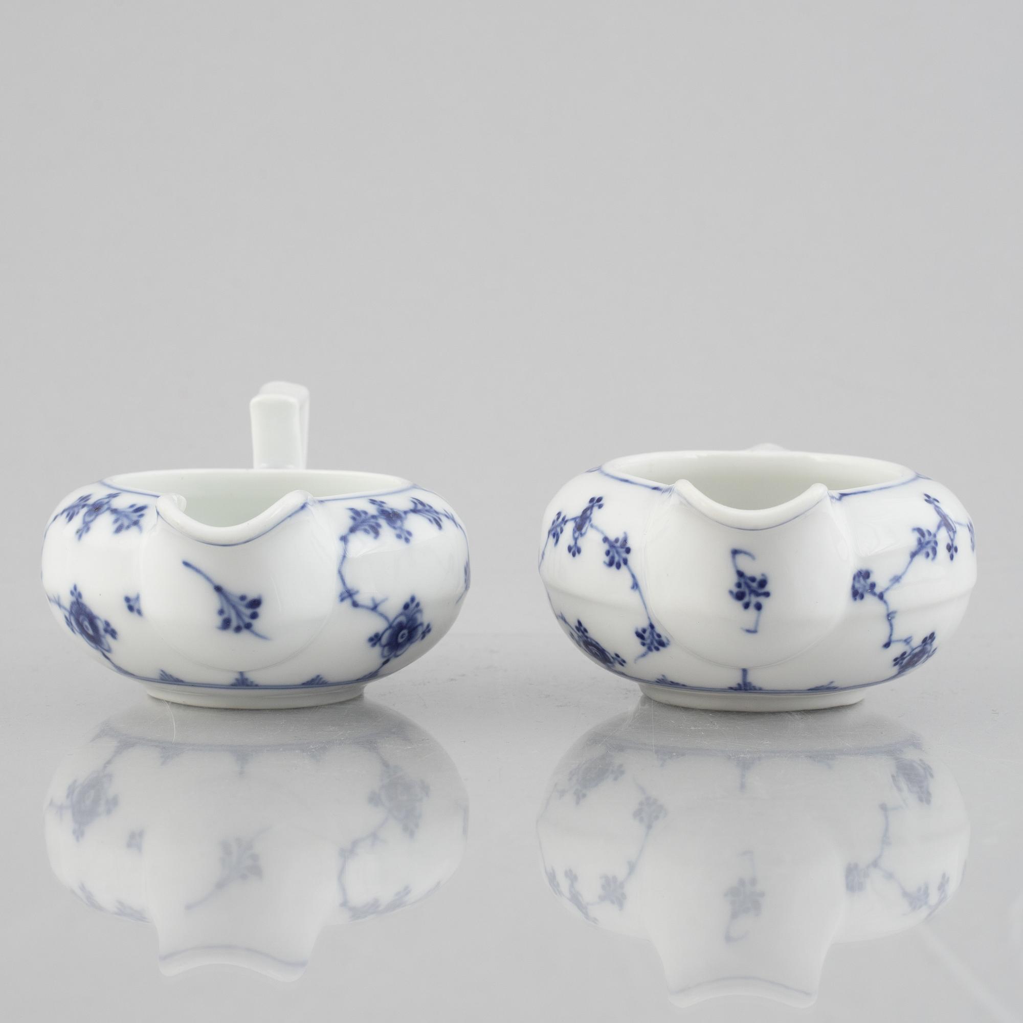 Two 'Musselmalet' porcelain creamers, Royal Copenhagen, one model 55, 19th century.