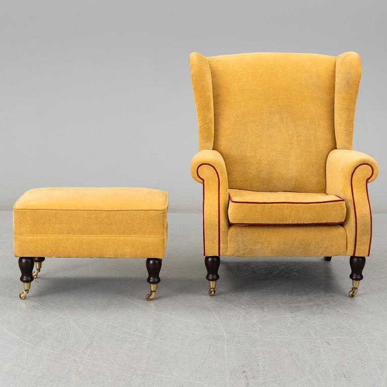 A 'York Wing Chair' easy chair with foot stool from Parker Knoll, 21st Century.