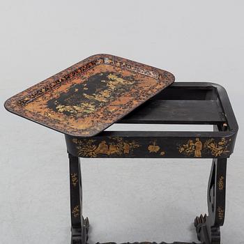 A black chinoiserie sewing table, second half of the 19th Century.