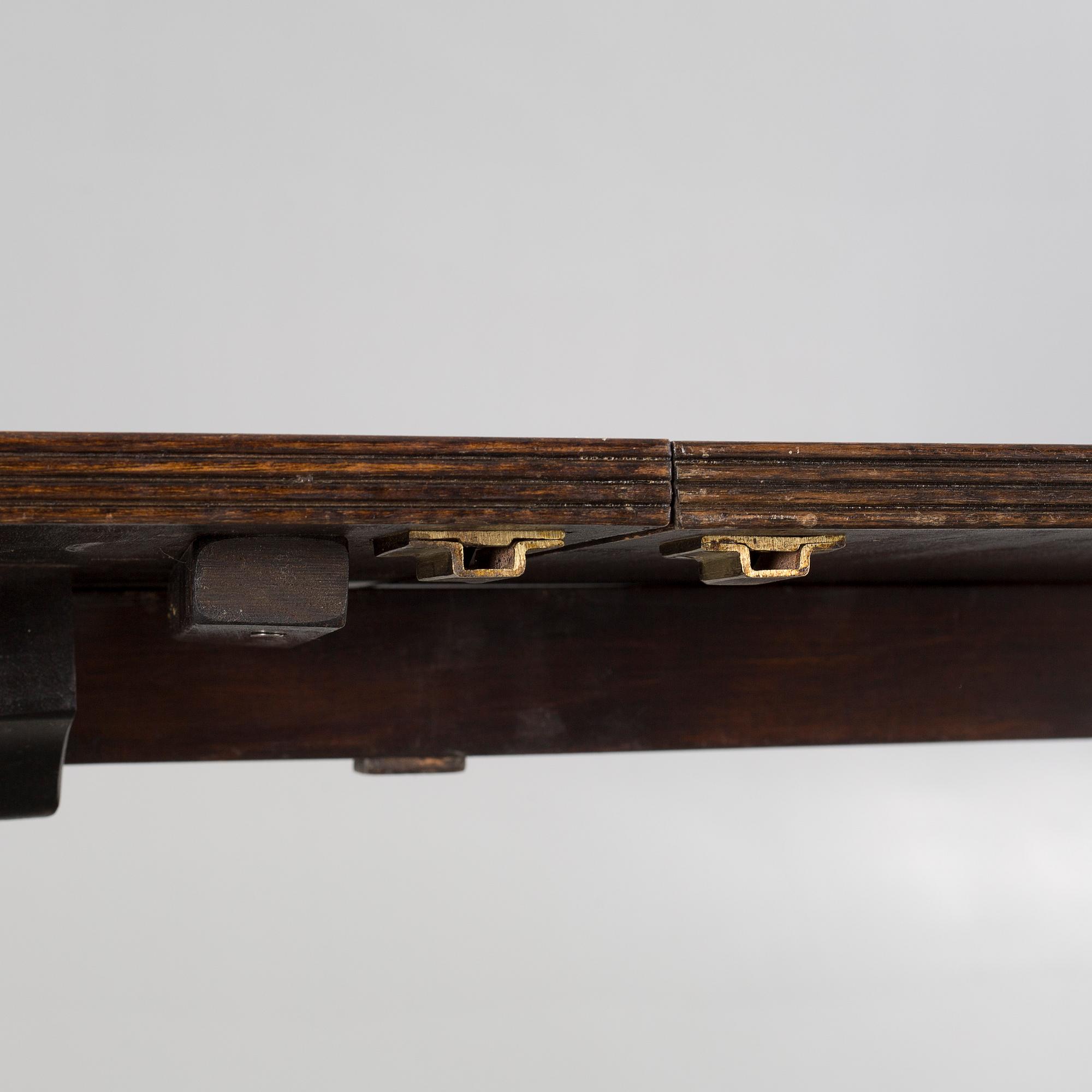 An english style dining table and eight chairs, second half of the 20th century.