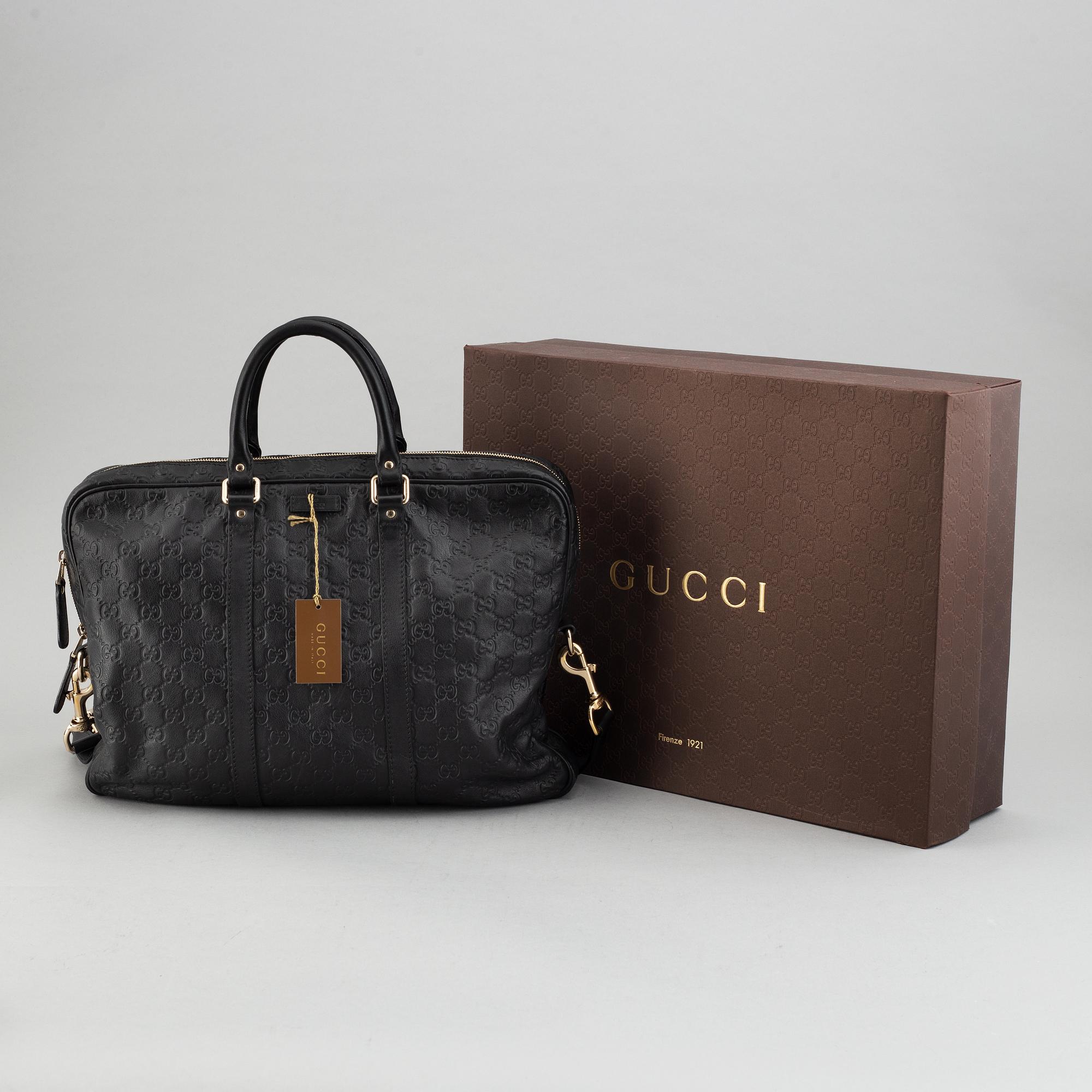 Gucci, a monogram leather bag/laptop-bag.