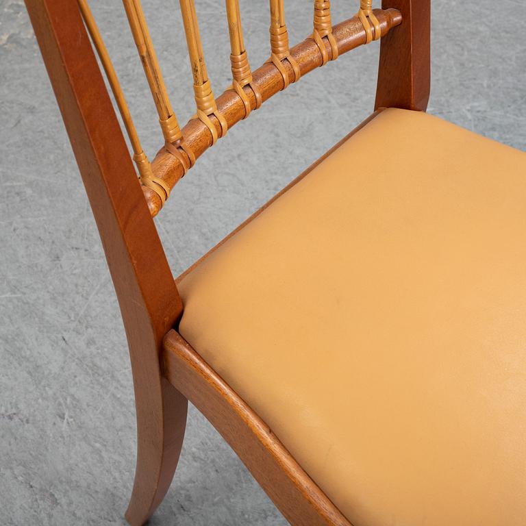 A set of four of Josef Frank mahogany and rattan dining chairs, Svenskt Tenn, Stockholm, Sweden.