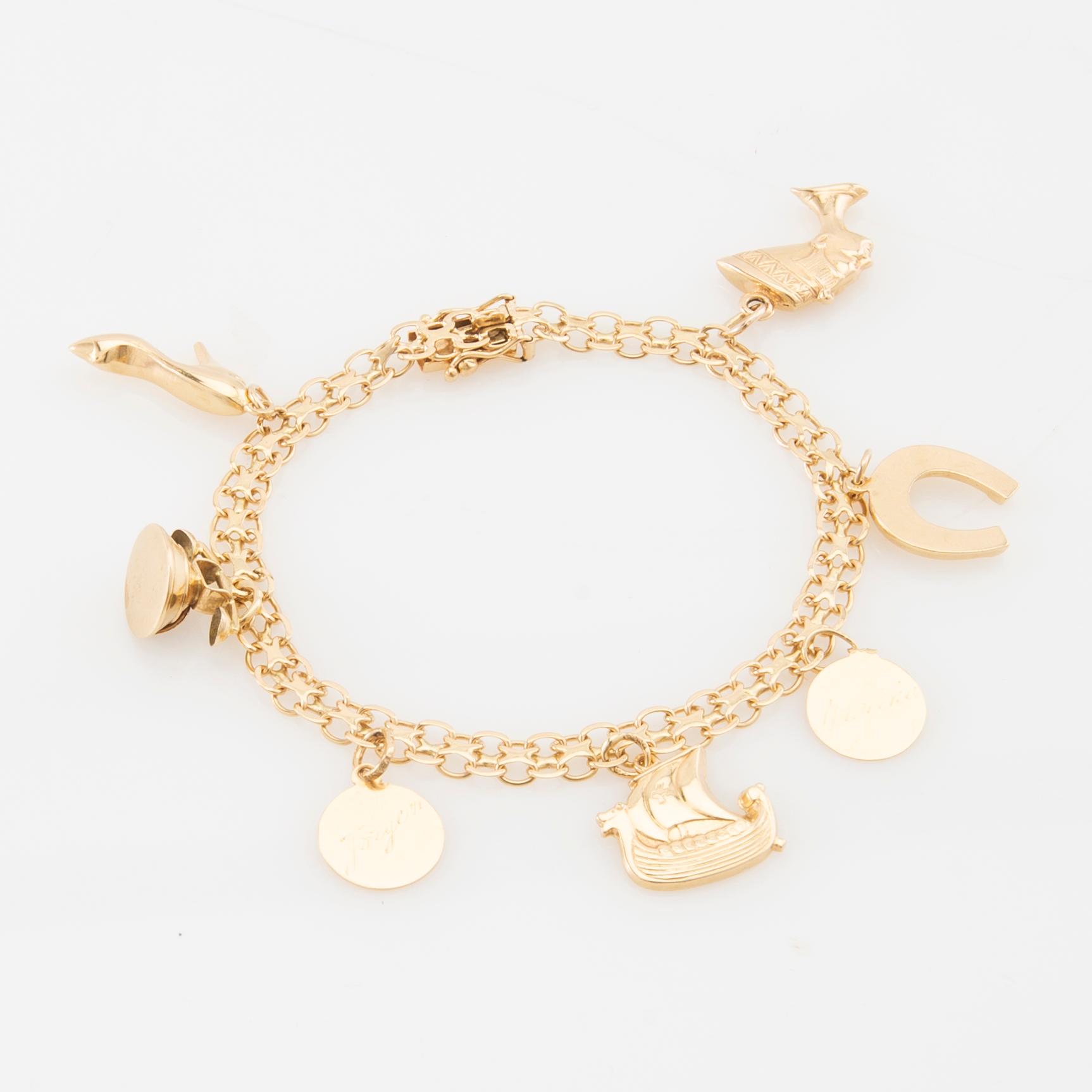 Bracelet 18K gold Bismarck link with charms.