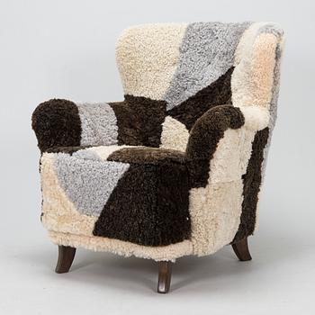 A 1950s lamb skin armchair.