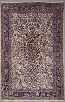 A CARPET, a semi-antique Kerman, ca 601 x 387 cm.