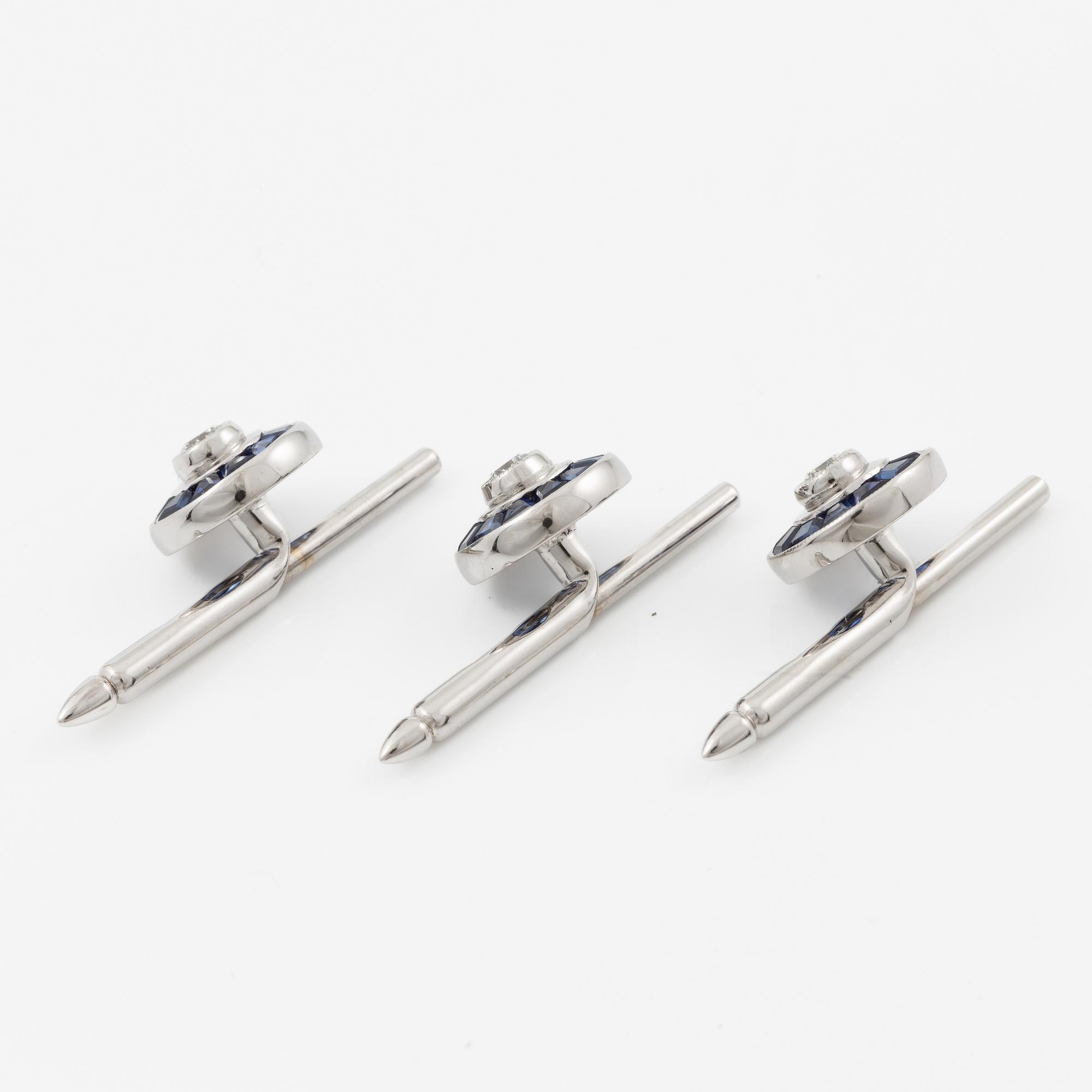 Three shirt buttons in 18K and 14K white gold set with faceted sapphires and round brilliant-cut diamonds.