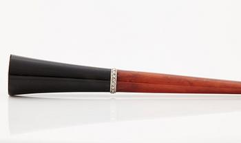 A 1920's cigarette holder of tortoiseshell and meerschaum decorated with rose-cut diamonds.