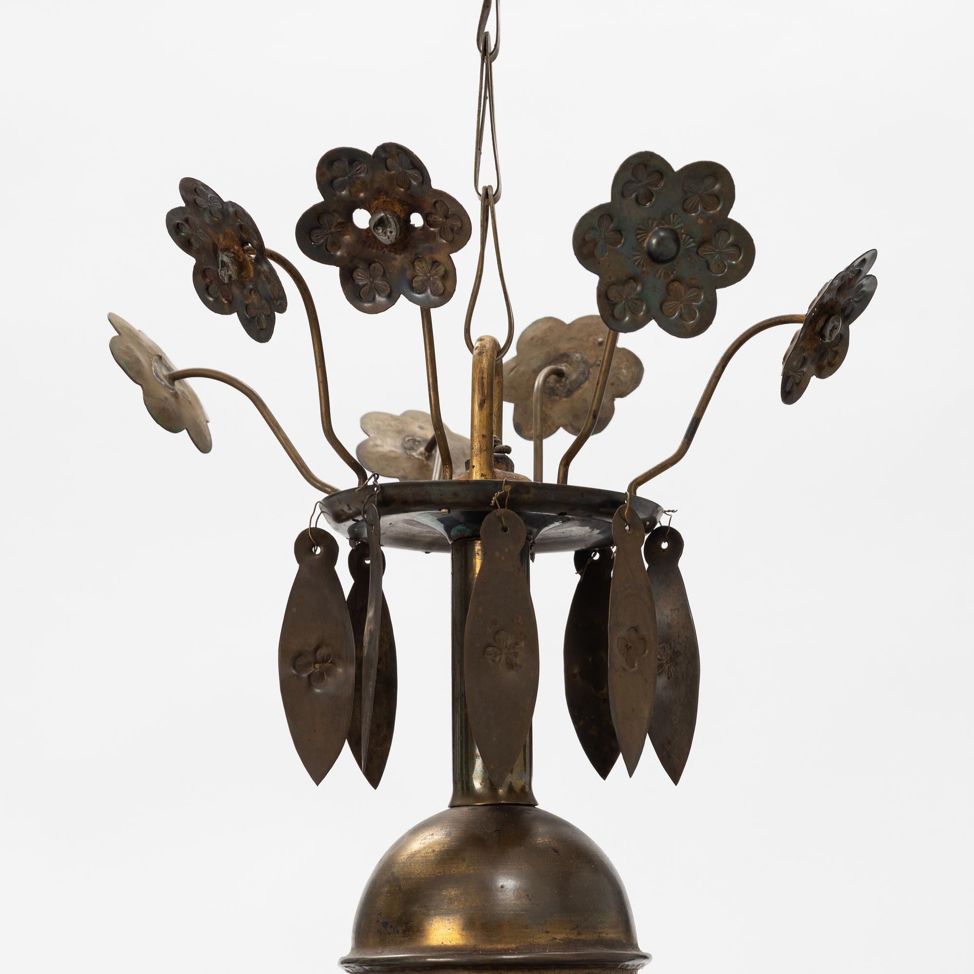 A Baroque style brass chandelier from around the year 1900.