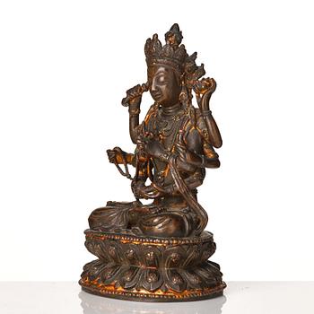 A cold gilt copper alloy figure of eight armed Boddhisattva Avalokiteshvara, late Ming dynasty.