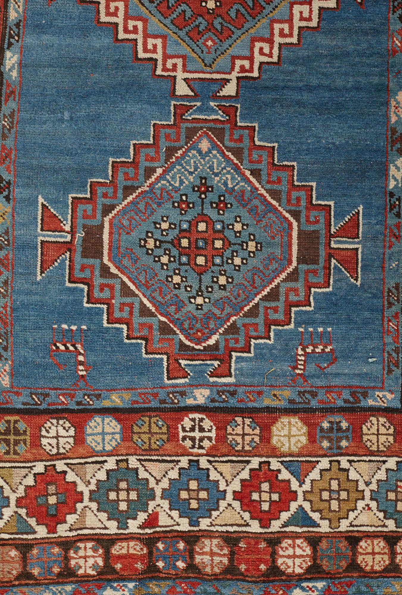 A RUNNER, a semi-antique Caucasian, ca 303,5 x 129,5-140,5 cm (as well as one end with 2,5 cm flat weave).