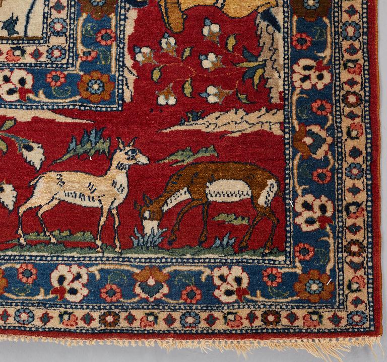 A CARPET, a semi-antique Teheran probably, a figural part silk, ca 347,5-345,5 x 242 cm.