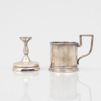 A Russian Silver Candlestick, 1908-26, and a Russian Silver Tea Glass Holder, assay master A. Skovronsky, Moscow 1896.