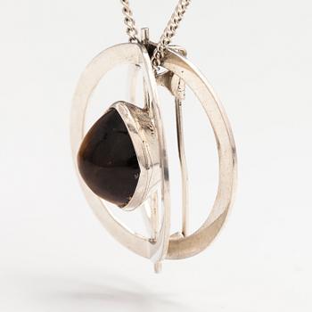 Elis Kauppi, A silver necklace/brooch with a tiger's eye. Kupittaan kulta, turku 1961.