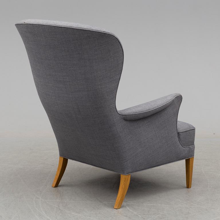 An easy chair and foot stool by Frits Hansen for Carl Hansen & Son.