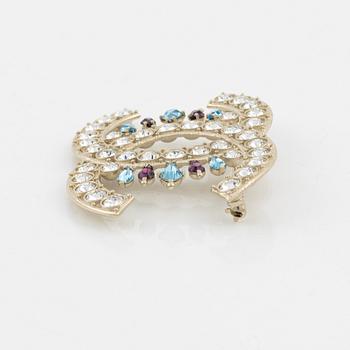 Chanel, a silvermetal, rhinestone and crystal brooch, 2019.