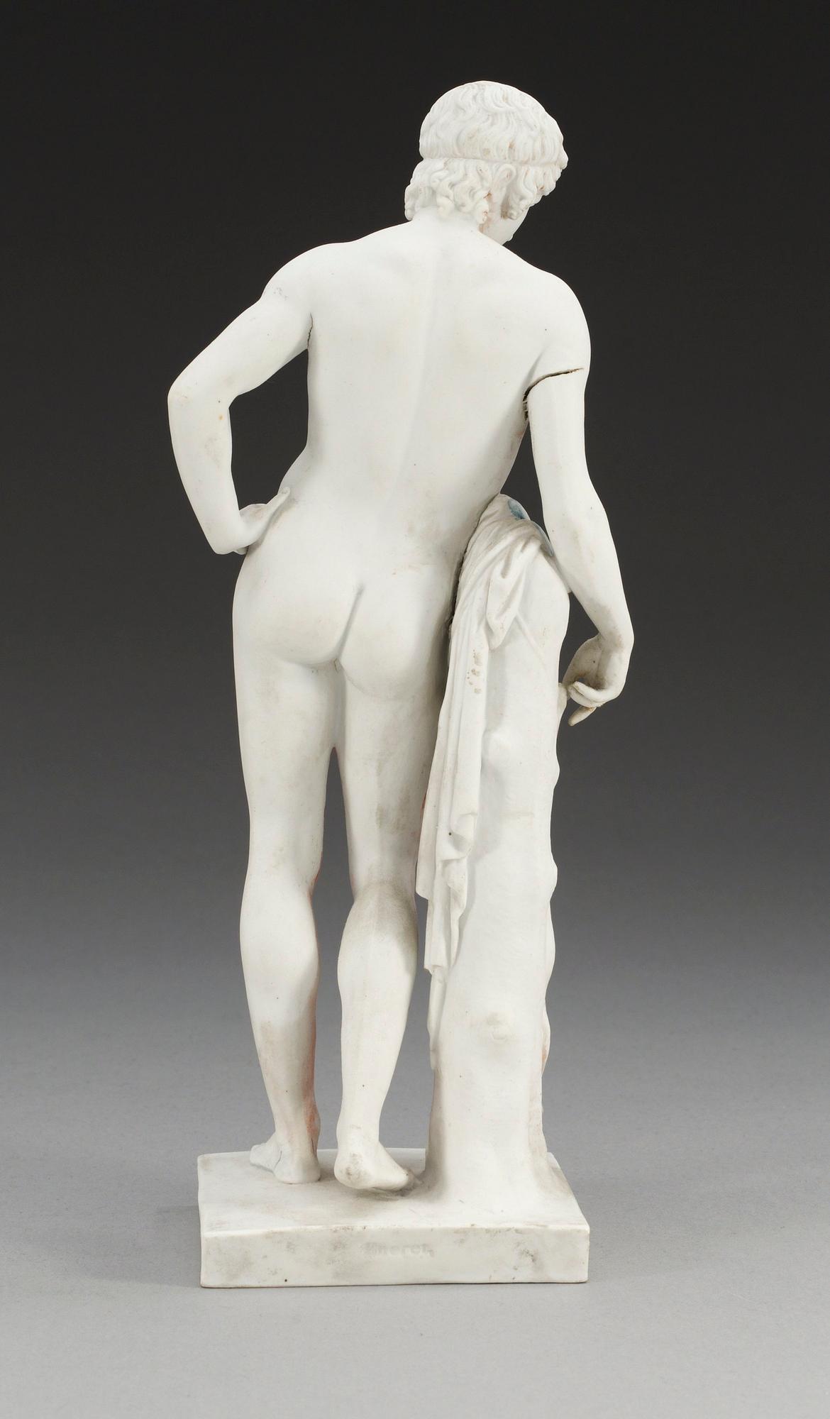 A Royal Copenhagen bisquit figure of a young man, 19th Century.