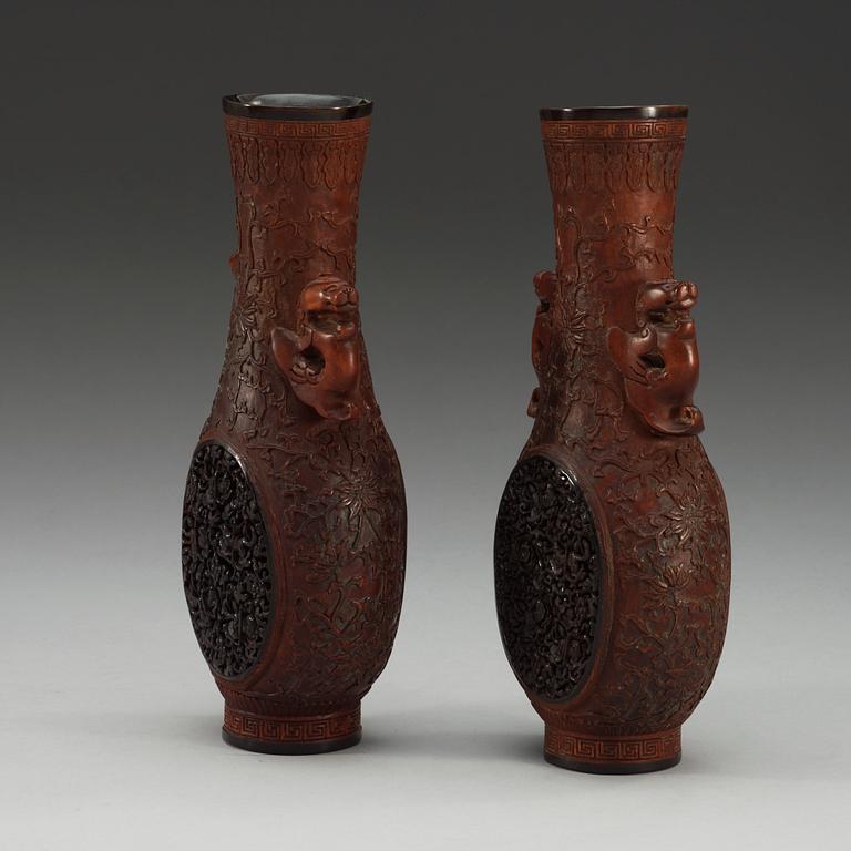 A pair of carved wooden and tortoise shell inlayed vases, presumably late Qing dynasty (1644-1912).