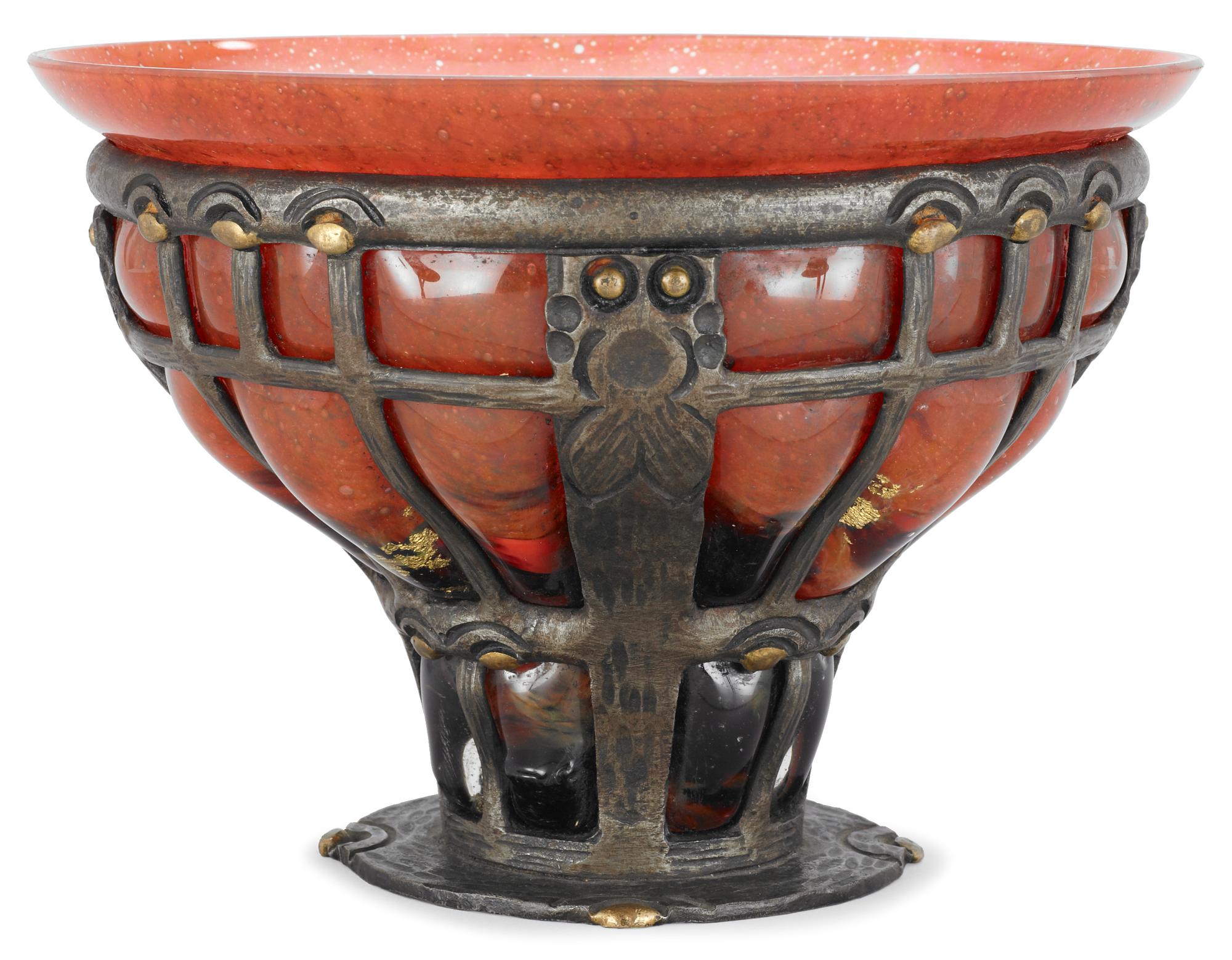 A Louis Majorelle orange glass bowl, Daum, Nancy, contained in an iron latticed frame, signed underneath.