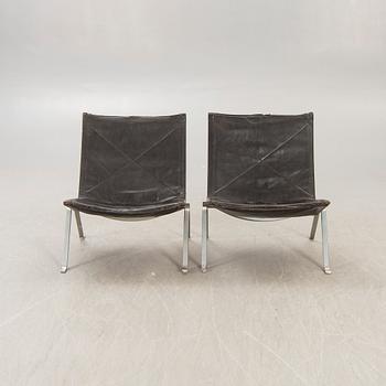 A pair of Poul Kjaerholm metal and leather PK22 easy chairs from Kold Christensen Denmark.