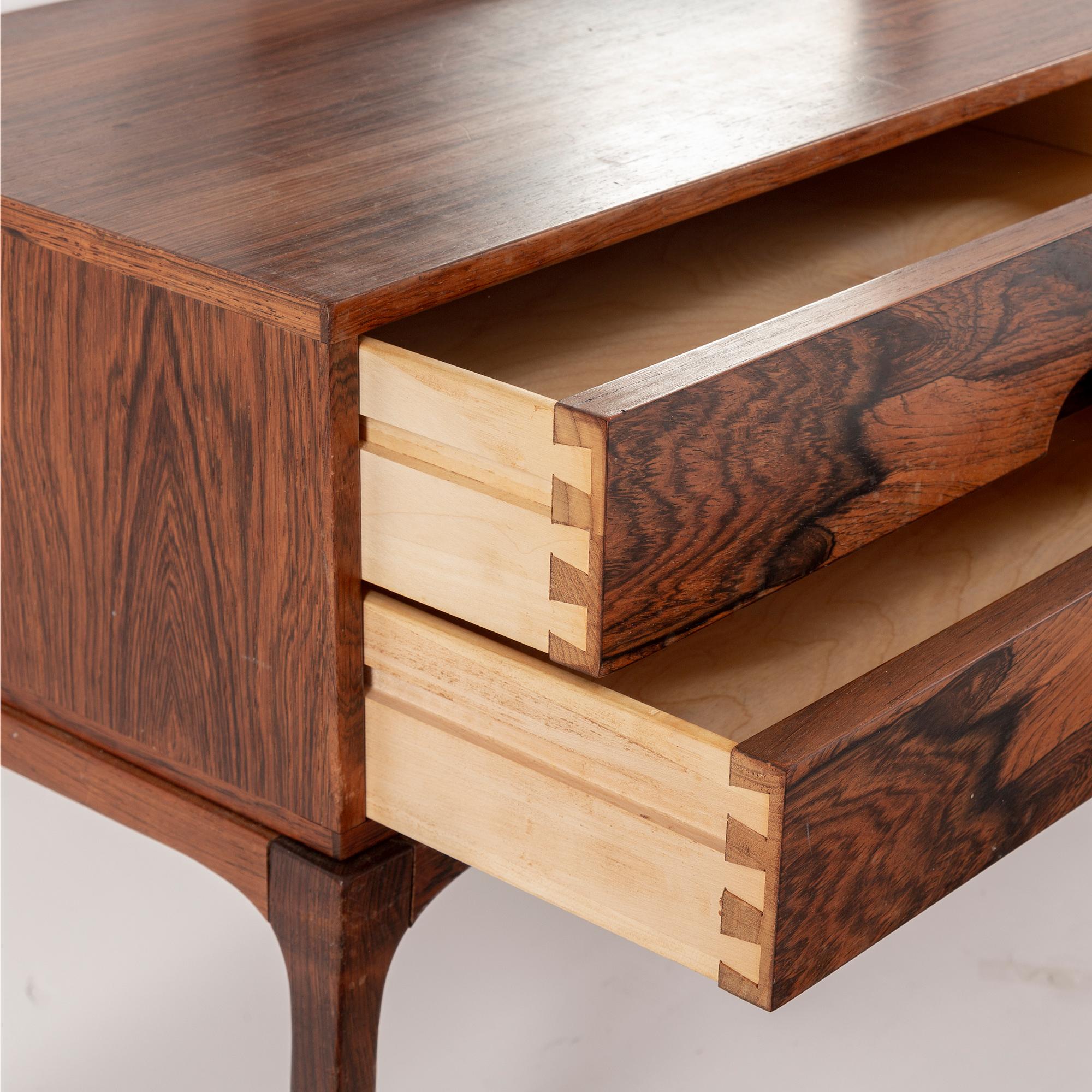 AKSEL KJERSGAARD, a rosewood mirror and chest of drawers from Odder, Denmark, 1960's.