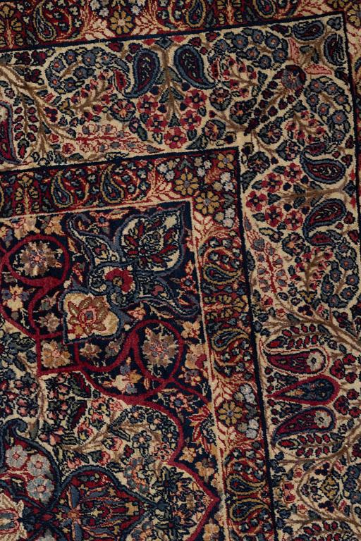 A carpet, semi-antique Kerman Laver, ca 242 x 142 cm.