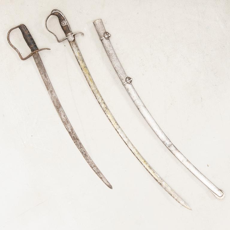 A German sabre with scabbard and a cutlass.