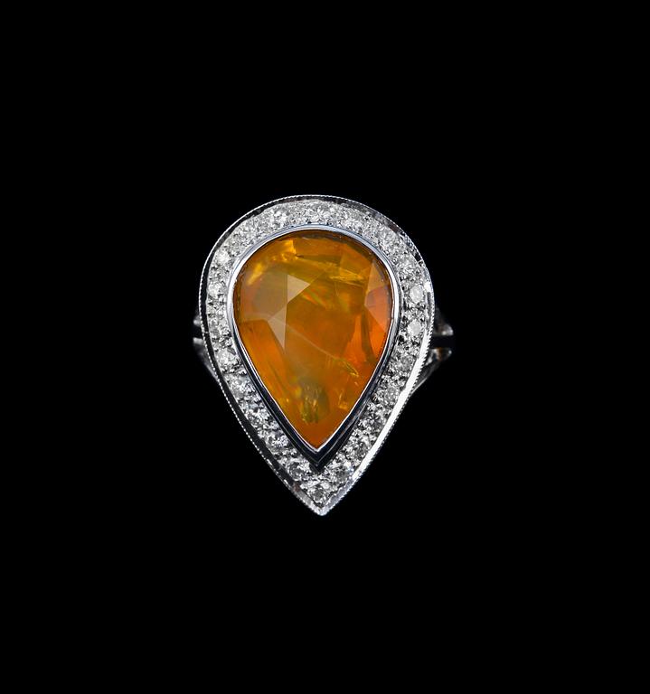 A RING, fire opal, brilliant cut diamonds c. 0.63 ct. 18K white gold. Weight 8,5 g.