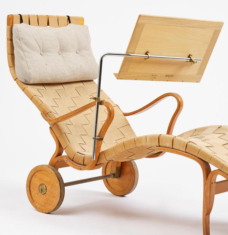 Bruno Mathsson, a lounge chair with wheels, Firma Karl Mathsson, Värnamo, 1940s, with reading table from 1972.