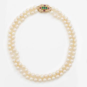 Pearl necklace, two-stranded, with a clasp by Seblings in 18K gold set with emeralds, rubies, and brilliant-cut diamonds.