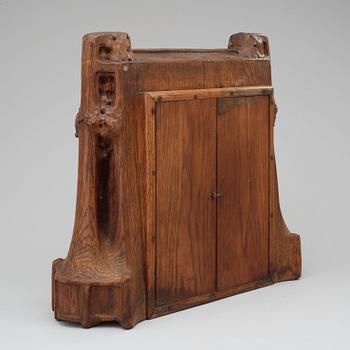 A Swedish Art Nouveau carved pine mantel clock, probably by Rackengruppen.