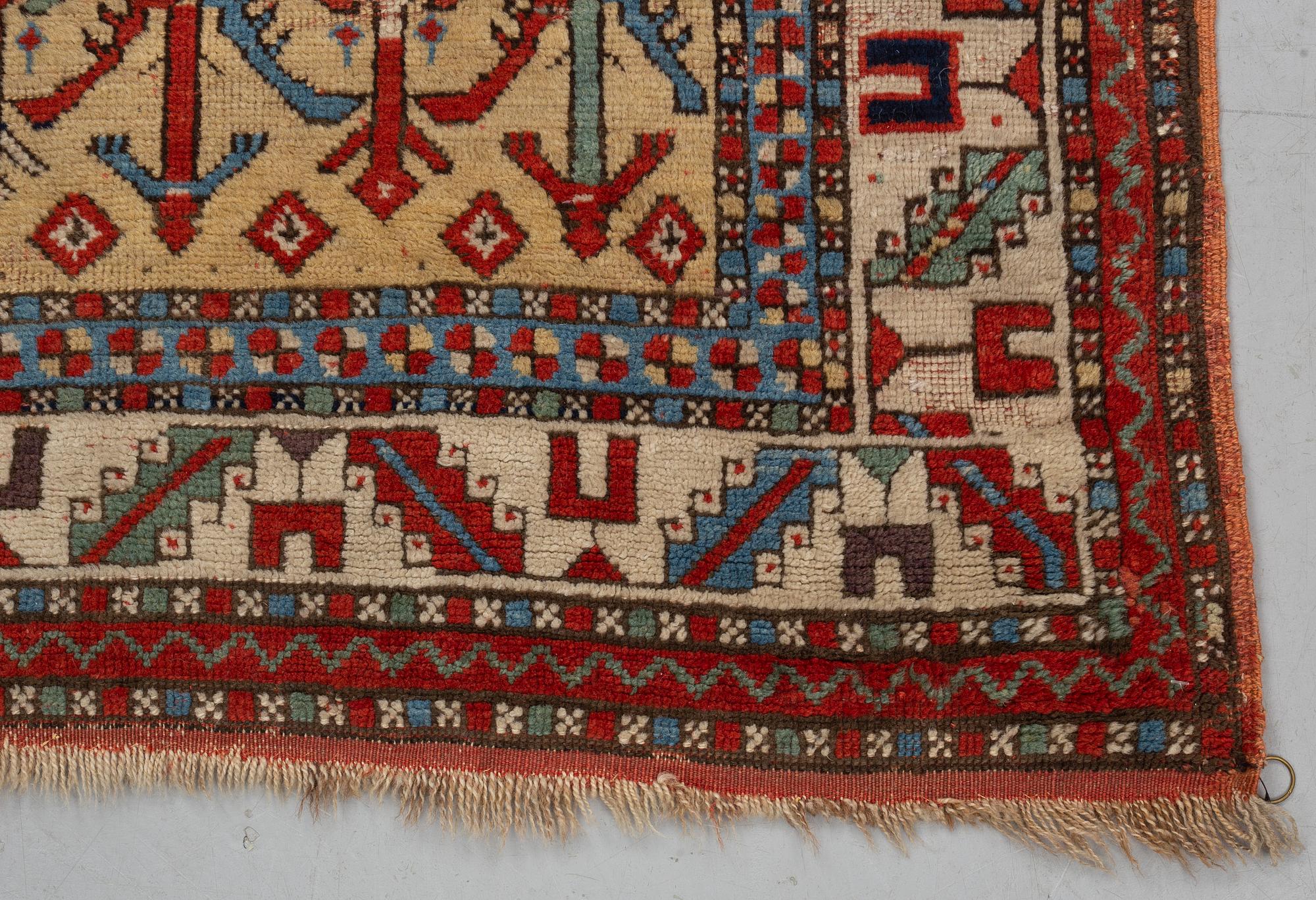A rug, antique Anatolian/Caucasian, ca 148-149 x 104,5-110 cm (as well as 1-1,5 cm flat weave at one end).