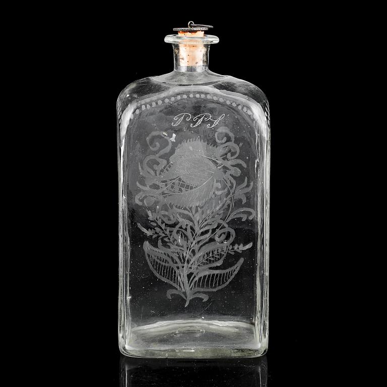 A glass bottle and three vodka glasses, 19th Century.