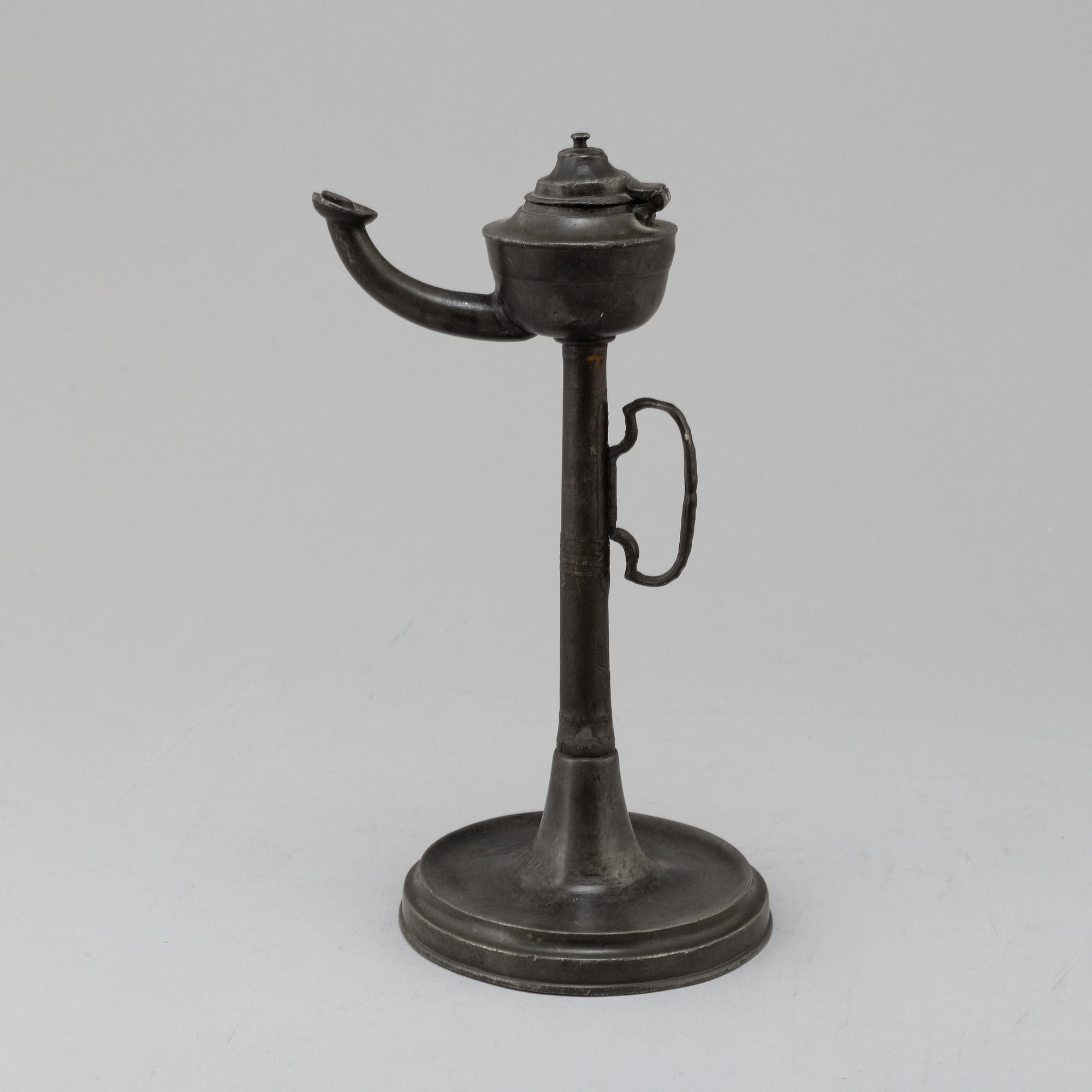 An 18th century pewter oil lamp.