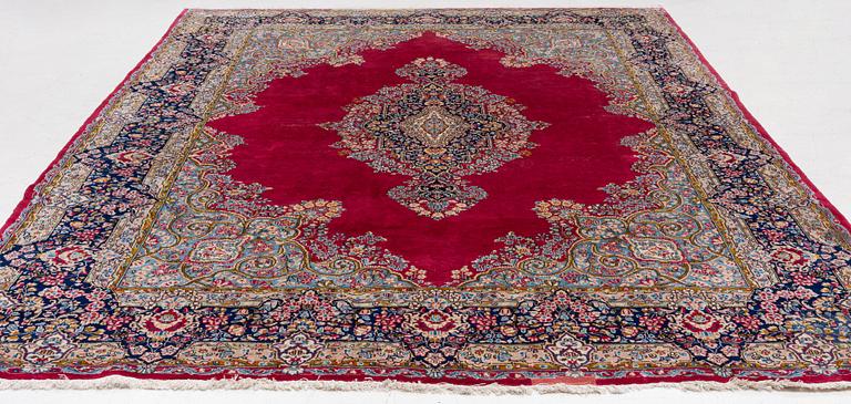 A Kirman carpet, signed, c. 388 x 279 cm.