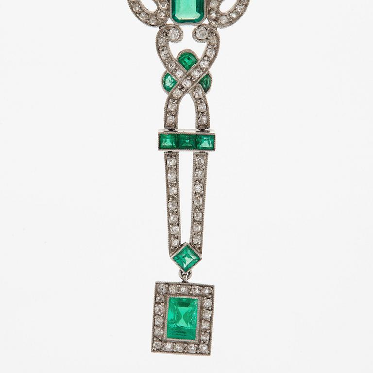 A platinum necklace set with faceted emeralds and old- and eight-cut diamonds.