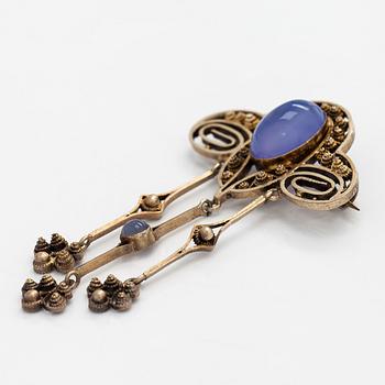 Brooch, cabochon-cut moonstones, gilded silver.